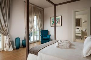 a bedroom with a bed and a blue chair at Villa Zara in Vabriga +42 photos