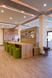 an office with a long table and green chairs at Berggasthof & Hotel Sennhütte in Fladungen