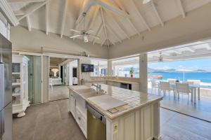 a large kitchen with a view of the ocean at Dream Villa Terres Basses 564 in Les Terres Basses