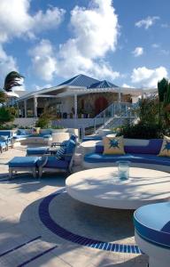 a group of chairs and tables in front of a building at Dream VIlla Terres Basses 575 in Les Terres Basses