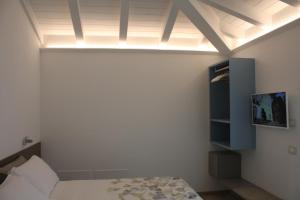 a bedroom with a bed and a tv on the wall at ARIA Design B&B Levanto in Levanto