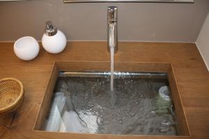 a sink with water coming out of it at ARIA Design B&B Levanto in Levanto