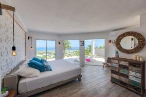 a bedroom with a bed with a view of the ocean at Dream Villa Orient Bay 566 in Orient Bay