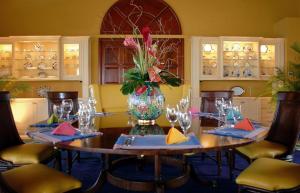 a dining room with a table with a vase of flowers at Dream VIlla Terres Basses 575 in Les Terres Basses