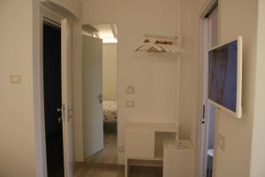 a hallway with a door and a television on a wall at ARIA Design B&B Levanto in Levanto
