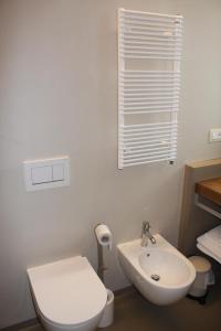 a bathroom with a white toilet and a sink at ARIA Design B&B Levanto in Levanto