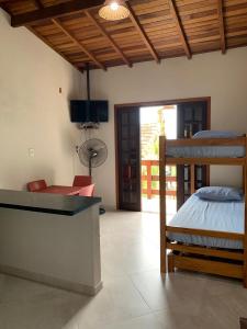 a bedroom with a bed and a view of a patio at Flats Alto das Pedras in Trindade