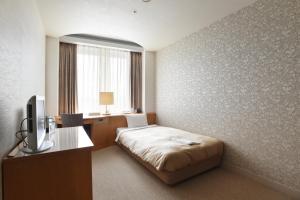 Postelja oz. postelje v sobi nastanitve Hotel Grand Vert Gizan