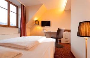 Ένα ή περισσότερα κρεβάτια σε δωμάτιο στο HKK Hotel Wernigerode