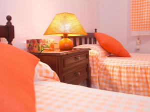 A bed or beds in a room at 2BR Beach House - Solarium & Shower Terrace - 12