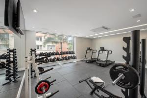 a gym with lots of equipment and a large window at Intercity Sao Leopoldo in São Leopoldo