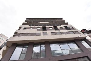 a tall building with lots of windows at Urban Apartment in Niš