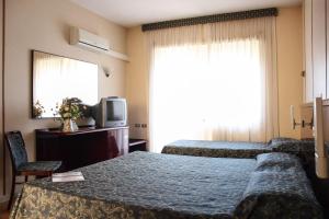 Кровать или кровати в номере Grand Hotel Dei Cesari Dependance