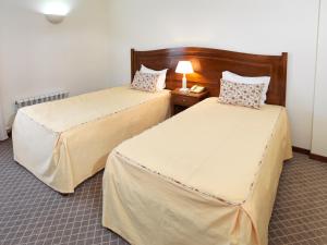 Cama ou camas em um quarto em Hotel Santa Maria