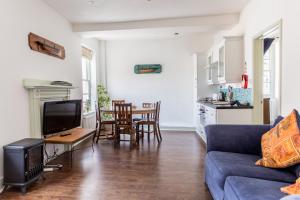 a living room with a blue couch and a table at Route 2 Apartments in Topsham