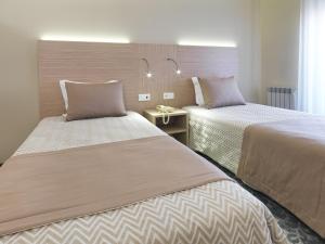 Cama ou camas em um quarto em Hotel Santa Maria