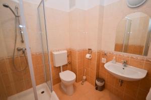 a bathroom with a toilet, sink, and shower at Broadway City Guesthouse in Budapest