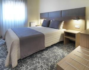 Cama ou camas em um quarto em Hotel Santa Maria