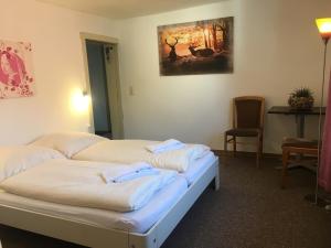 a room with two beds with towels on them at Harz House in Trautenstein