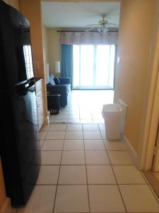 a living room with a large window and a tile floor at Coconut Malorie Resort Ocean City a Ramada by Wyndham in Ocean City