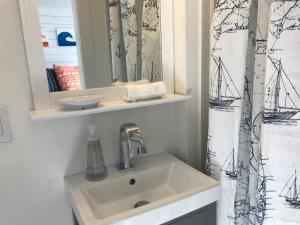 a bathroom with a sink and a mirror at Breakwater Hotel in Provincetown