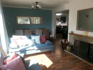 a living room with a couch and a fireplace at Snowdonia Mawddach escape in Dolgellau