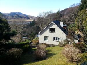 a white house on the side of a hill at Snowdonia Mawddach escape in Dolgellau