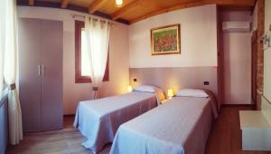 A bed or beds in a room at Agriturismo le Colonie