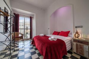 Łóżko lub łóżka w pokoju w obiekcie Apartamentos Jerez