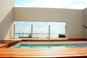 a house with a swimming pool with a large window at DonSuites in Corrientes