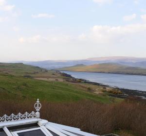 a building with a view of a body of water at Old Nurses Cottage in Skeabost