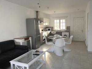 uma cozinha e sala de estar com um sofá e uma mesa em Villa Oasis em Puerto del Carmen