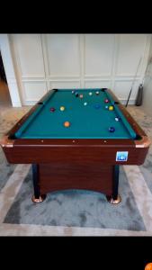 a pool table with balls on top of it at شقق درر رامه للشقق المخدومة 9 in Riyadh