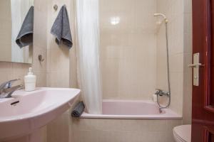 a bathroom with a sink and a shower and a tub at Apartamentos Estudio Nuevo en Puerto de la Cruz in Puerto de la Cruz