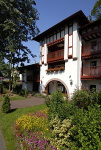 a building with balconies and flowers in front of it at Residence Parc Arradoy in Saint-Jean-Pied-de-Port