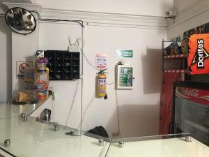 a room with a glass table and a wall at Hotel SION in Pitalito