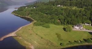 an aerial view of a house on an island in the water at Kilcamb Lodge Hotel in Strontian