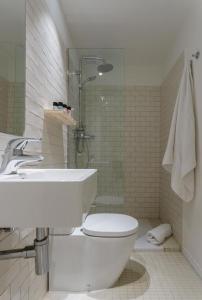 a bathroom with a toilet and a sink and a shower at Hotel Eolo in Port de Pollensa