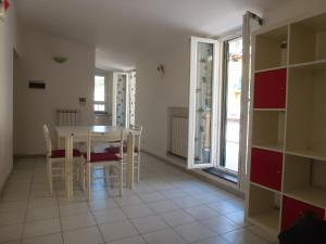 a kitchen and dining room with a table and chairs at Riomaggiore Attico in Riomaggiore