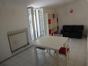 a living room with a table and chairs and a couch at Riomaggiore Attico in Riomaggiore