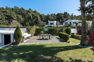 a garden with a picnic table in the yard at Possidi Villa Glamour by Luxlikehome in Possidi