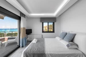 a bedroom with a large bed and a large window at Possidi Villa Glamour by Luxlikehome in Possidi +34 photos