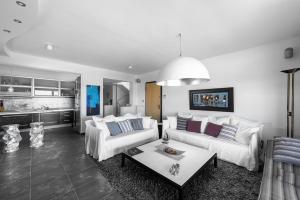 a living room with two white couches and a table at Possidi Villa Glamour by Luxlikehome in Possidi