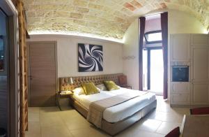 ガラティーナにあるDi Volta in Volta - Affitti breviの石壁のベッドルーム1室(大型ベッド1台付)