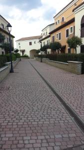 a cobblestone street with buildings and a street light at Attico in complesso turistico in Policoro