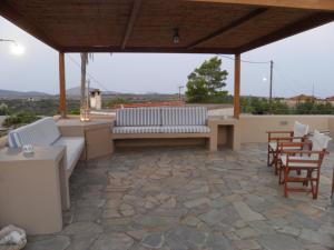 a patio with a couch and chairs and a table at Kytherian Traditional Home in Frilingiánika