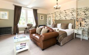 a hotel room with a bed and a couch at Three Ways House Hotel in Chipping Campden