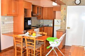 a kitchen with a table and chairs in a kitchen at LIRA in Larnaka +6 photos