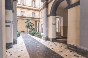 a hallway of a building with an archway and plants at Alchimia di Mare in La Spezia