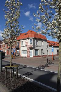 un bâtiment avec un toit rouge dans une rue dans l'établissement vakantiehuis-oyenkerke 2, à La Panne